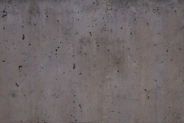 dark grey cement with damage in form of small pinholes