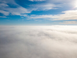 High flight over the fog. Aerial drone view.