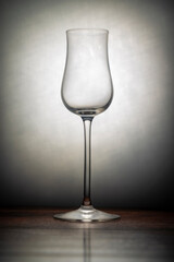 Transparent drinking glass on brown wooden old table with white backround