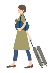 キャリーバッグに入れた猫と、スーツケースを運んでいる女性（帰省やペット旅行等のイメージに）