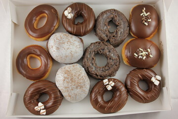 chocolate glazed Donuts covered with sugar crumbs in white background isolated close-up. Valentine's donuts. top view