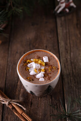 Cocoa with marshmallows and citrus zest on christmas background