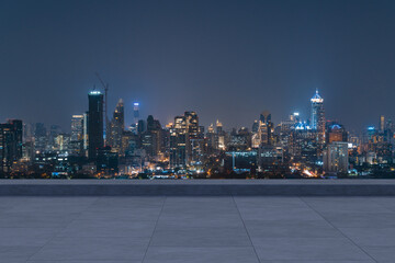 Panoramic Bangkok skyline view, concrete observatory deck on rooftop, night time. Asian corporate...