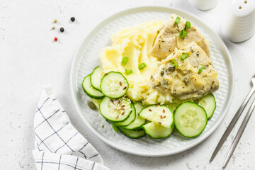 Mashed potatoes, cucumber salad, stewed chicken. Top view, copy space.