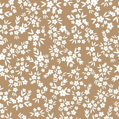 Vintage floral background. Seamless vector pattern for design and fashion prints. Floral pattern with small white flowers and leaves on a terracotta background.