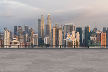 Fototapeta na wymiar Panoramic Kuala Lumpur skyline view, concrete observatory deck on rooftop, sunset. Asian corporate and residential lifestyle. Financial city downtown, real estate. Product display mockup empty roof