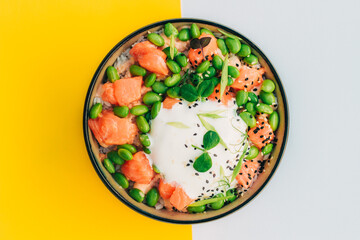 Organic and healthy food. Hawaiian poke Top view on white and yellow background