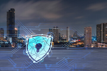 Rooftop with concrete terrace, Bangkok night skyline. Cyber security concept to protect clients confidential information. IT hologram padlock icons. City downtown. Double exposure.