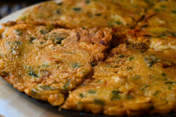 Korean seafood pancake (Haemul pajeon) - a crispy chewy aromatic onion pancake topped off with squid rings and shrimp