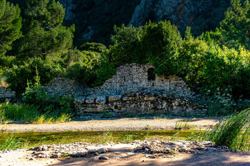 Fototapeta na wymiar ruins of ancient buildings on the background of mountains in the antique city of Olympos, Turkey