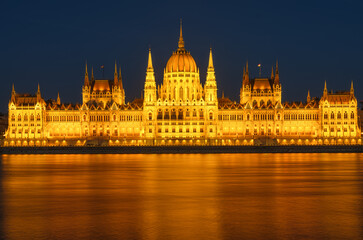 Fototapeta na wymiar Parliament building in Budapest, Hungary. Parliament and reflections in the Danube River.
