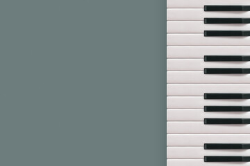 Fototapeta na wymiar 2022. Musical border with square copy space made of piano keys isolated on gray background. Minimal flat lay. Creative abstract concept. Music festival, concert or piano training note card. Top view. 