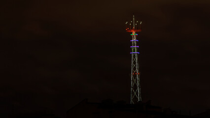 Panoramic view of illuminated TV broadcasting tower at night in Minsk. Night scenery with TV Tower in Minsk.