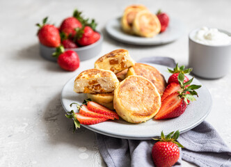 Layered dessert in glass jar with cookie crumble and whipped cream decorated with rosemary and anise. No bake cheesecake, trifle or pudding.