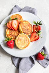 Layered dessert in glass jar with cookie crumble and whipped cream decorated with rosemary and anise. No bake cheesecake, trifle or pudding.