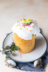 Kulich. Traditional Orthodox Easter sweet bread decorated with meringue icing and candy shaped eggs.