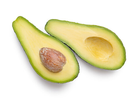 Ripe avocado on a white background, halves of avocado.