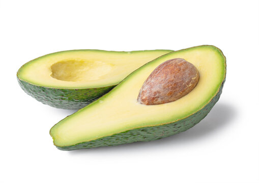 Ripe avocado on a white background, halves of avocado.