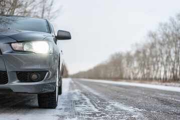 Car travel concept. Car on the empty snowy road background.