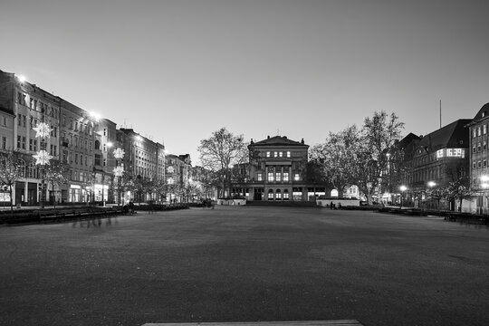 square and buildings decorated for Christmas evening in Poznan, monochrome
