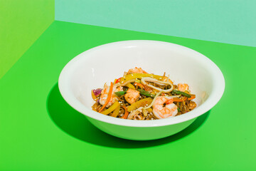 Spicy Stir Fried Instant Noodle with Seafood and basil on green