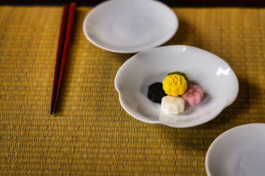 Closeup of colorful dasik pastry served on white porcelain dish on a mat