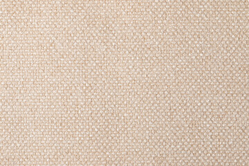 The texture of the fabric. Beige jacquard close-up. Soft expensive fabric for furniture, curtains, pillows and car upholstery. Background. A place to copy.
