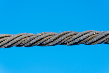 The aluminum electrical wire is covered with frost.