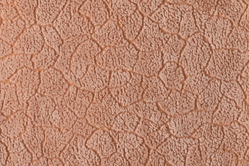 The texture of the fabric. Beige velour close-up. Soft expensive fabric for furniture, curtains,...