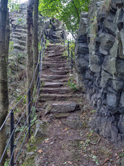 Stony stairs in forest tourist footpath. Basalt stairs in spring forest