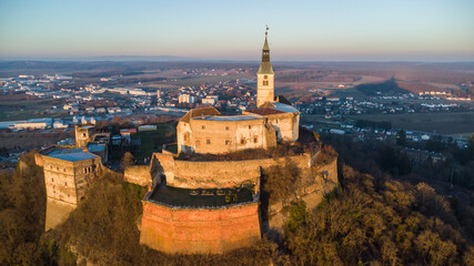 Fototapeta na wymiar Aerial view of ancient castle Burg Güssing in Burgenland, Austria in a beautiful winter evening sunset mood 