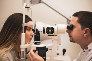 A girl visits an optician and undergoes a cutting lamp for the exploration of the ocular media