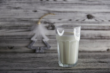 Glass of fresh milk on the wooden vintage background with copy space. Organic milk. Healthy wellness background