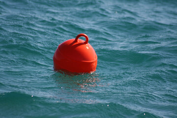 Red mooring buoy in the sea