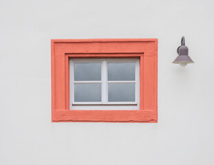 One windows and lamp  in the facade of a  colorful building
