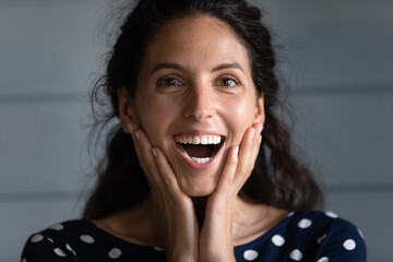 Head shot joyful young beautiful hispanic woman looking at camera with open mouth, feeling excited...
