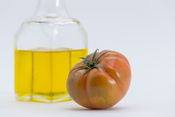 tomato and oil can on white background