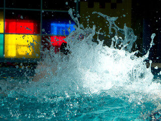 Water splash in the swimming pool close up