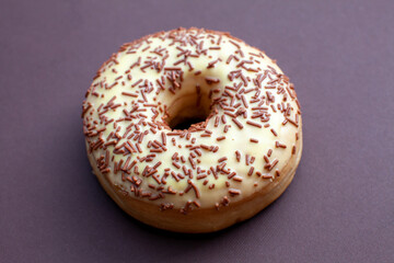 vanilla doughnut on brown background