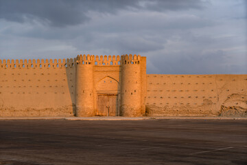 Uzbekistan, sunset in the city of Bukhara, a restored gate in the Shaybinid Wall. 