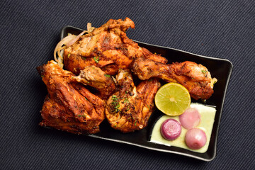 Indian Style Roasted Chicken with Lemon and Onion in Plate