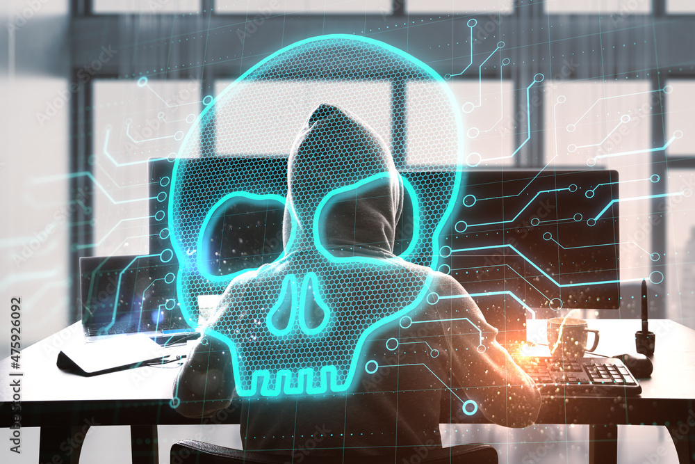 Leinwandbilder Abstract image of hacker at desktop using computers with glowing digital skull on blurry background. Hacker, technology and virus concept. Double exposure.