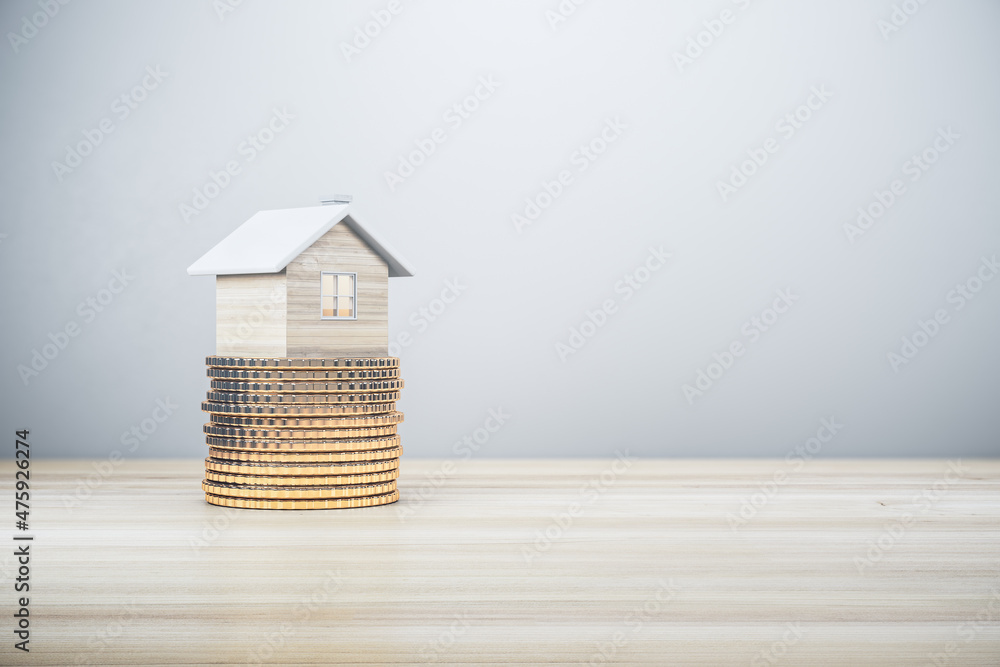 Poster abstract house on golden coins stack. light wooden background with mock up place. mortgage, money an