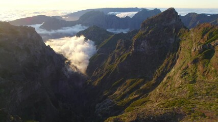 Scenic sunset in the volcanic mountains of Madeira near Pico do Areiro, aerial view of beautiful sunset on the island of Madeira, flying in a mountain valley, hiking, active tourism concept