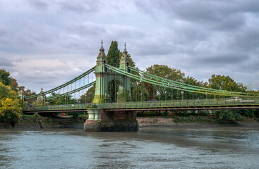 View of Hammersmith Bridge, a Grade II listed suspension bridge that crosses the River Thames, connecting Hammermith to Barnes, in west London.
