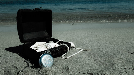 a pirate treasure chest on a sandy beach.a treasure trove of seashells, antique watches and jewelry...
