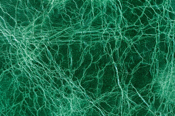 Bright emerald green leather, cracked texture closeup