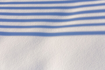 Some shadow lines in white snow in winter