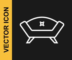 White line Sofa icon isolated on black background. Vector