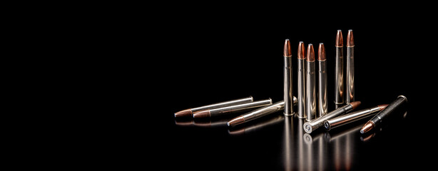 Bullet isolated on black background with reflexion. Rifle bullets close-up on black back....